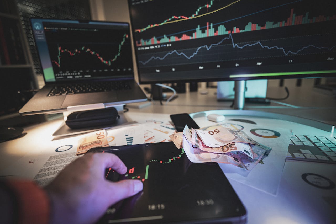 A modern trading desk with screens showing market charts and euro notes, capturing a trading atmosphere.